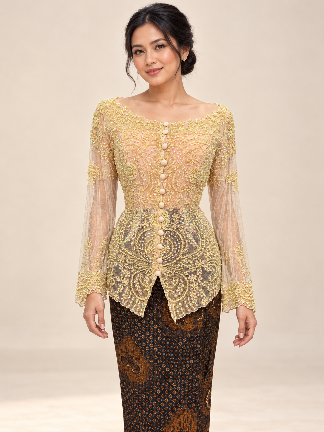Kebaya Kendedes in pale yellow with intricate beadwork, styled with a dark brown batik skirt on a model against an ivory studio background.
